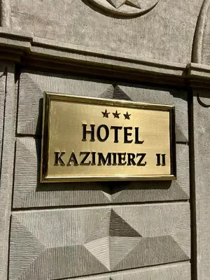 a sign on the side of a building at Hotel Kazimierz II in Kraków
