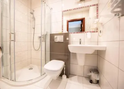 a bathroom with a toilet and a sink and a shower at Hotel Kazimierz II in Kraków