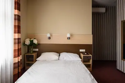 a bedroom with a large bed with two night stands at Hotel Kazimierz II in Kraków