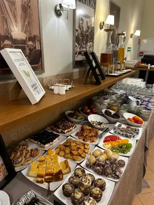 a buffet line with many different types of pastries at Hotel Kazimierz II in Kraków