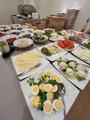 a table with many plates of food on it at Hotel Kazimierz II in Kraków