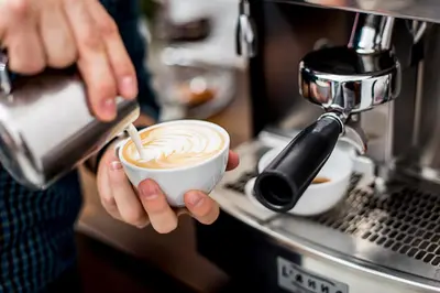 a person is holding a cup of coffee at Abella Suites & Apartments by Artery Hotels in Kraków