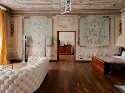 a room with a brick wall and tables and chairs at Hotel Stary in Kraków