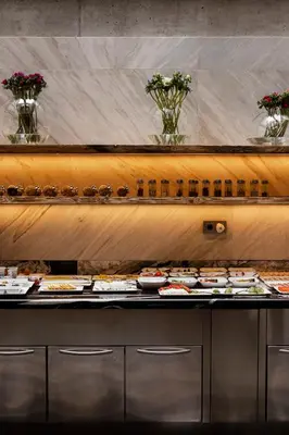 a table with three plates of pastries and other desserts at Hotel Stary in Kraków