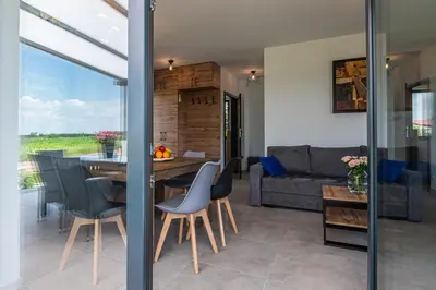 a kitchen with a counter with a microwave and a window at Domki Całoroczne PREMIUM Zator ENERGYLANDIA in Zator