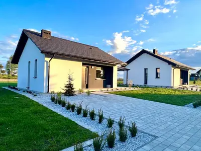 a bedroom with two beds and a tray on the bed at Domki Całoroczne PREMIUM Zator ENERGYLANDIA in Zator