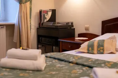 a hotel room with a bed with towels on it at Aparthotel Karmel in Kraków