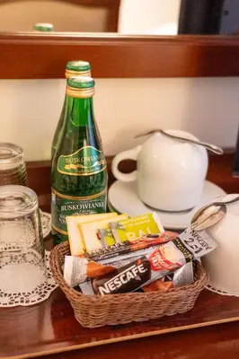 a basket of food and a bottle on a table at Aparthotel Karmel in Kraków