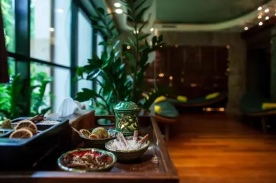 a table with bowls of food on top of it at Farmona Hotel Business & SPA in Kraków