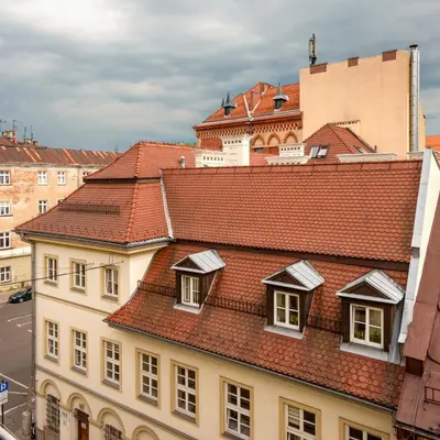 a building with red tile roofs in a city at Kazimierz Secret in Kraków