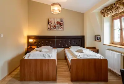 a bedroom with two beds and a window at Kazimierz Secret in Kraków