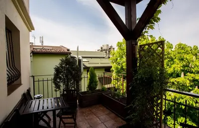 a balcony with a bench and plants on a building at Kazimierz Secret in Kraków