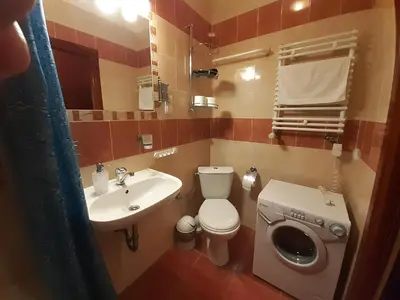 a small bathroom with a toilet and a sink at Kazimierz Secret in Kraków