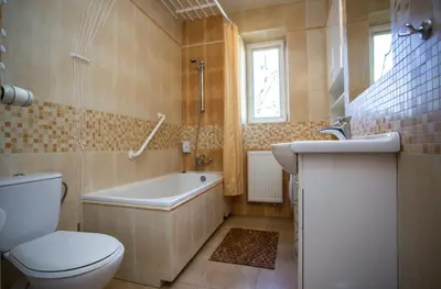 a bathroom with a toilet and a tub and a sink at Kazimierz Secret in Kraków