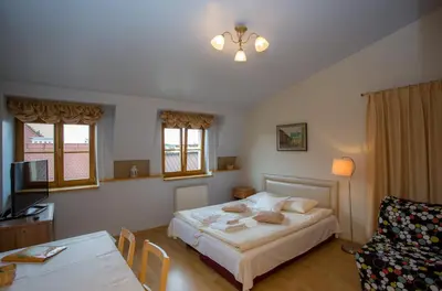 a bedroom with a bed and a table and a couch at Kazimierz Secret in Kraków