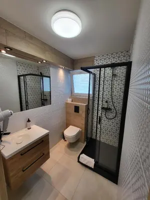 a bathroom with a shower and a toilet and a sink at Kraków Garden Hotel- jesteśmy w trakcie modernizacji in Kraków