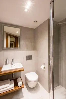 a bathroom with a toilet and a sink and a shower at Ascot Premium Hotel in Kraków