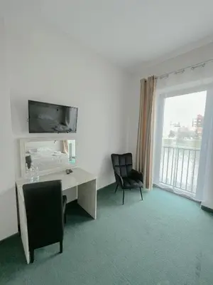 a room with a desk and a chair and a window at Hotel Poleski in Kraków