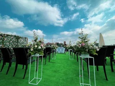 a row of tables and chairs with flowers on them at Hotel Poleski in Kraków