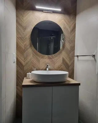 a bathroom with a white sink and a mirror at Wy_spa_Podolany in Gdów