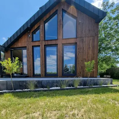 a wooden house with large windows at Wy_spa_Podolany in Gdów