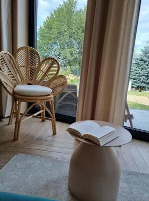 a room with two chairs and a table with a book at Wy_spa_Podolany in Gdów