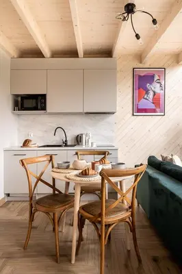 a kitchen with a table and chairs in a room at Wy_spa_Podolany in Gdów