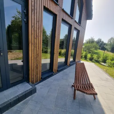 a wooden bench sitting outside of a building at Wy_spa_Podolany in Gdów