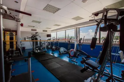 a gym with several treadmills and machines at Qubus Hotel Kraków in Kraków