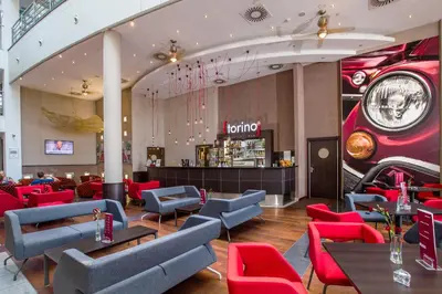 a restaurant with red and blue chairs and a bar at Qubus Hotel Kraków in Kraków