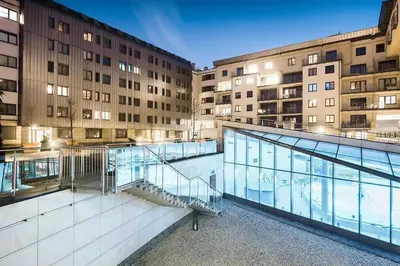 a view of a building with a swimming pool at Laurel White Apartment with Jacuzzi Bath and Pool Access in Kraków