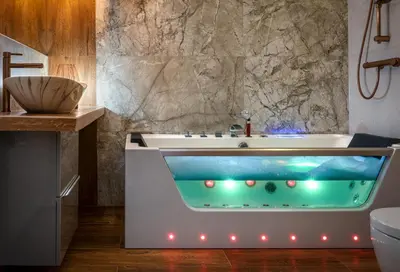 a bathtub with lights in a bathroom at Laurel White Apartment with Jacuzzi Bath and Pool Access in Kraków