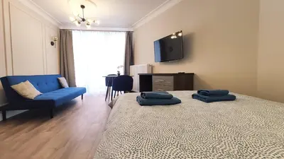 a bedroom with a bed with two blue pillows on it at Ariańska 8A by Homeprime in Kraków