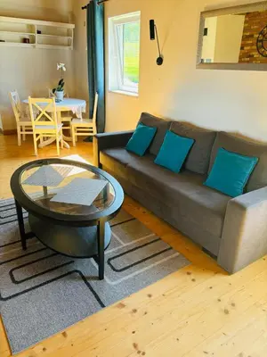 a living room with a couch and a table at Dom pod Jabłonką in Stronie