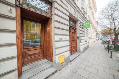 a wooden door on the side of a building at Dizzy Daisy Hostel in Kraków