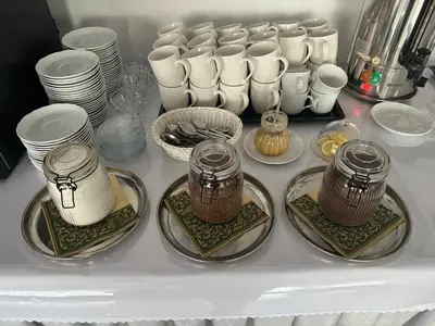 a refrigerator filled with plates and cups and dishes at Hotel Junior 2 in Kraków
