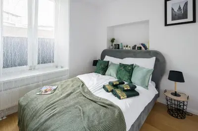 a bedroom with a bed with two pillows on it at Powiśle 4 by Homeprime in Kraków