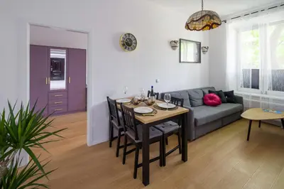 a living room with a table and a couch at Powiśle 4 by Homeprime in Kraków
