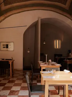 a bedroom with a bed and a large window at Hotel Pod Różą in Kraków