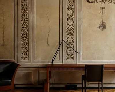 a room with a chair and a table and a window at Hotel Pod Różą in Kraków