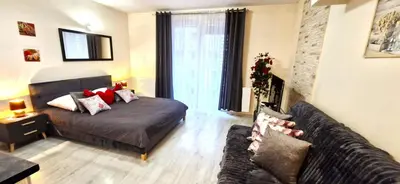 a living room with a bed and a couch at Cracow NOVUM Apartment Downtown 4 persons in Kraków