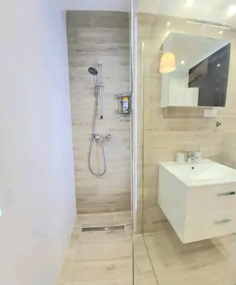 a bathroom with a shower and a sink at Cracow NOVUM Apartment Downtown 4 persons in Kraków