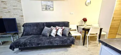 a living room with a couch and a table at Cracow NOVUM Apartment Downtown 4 persons in Kraków