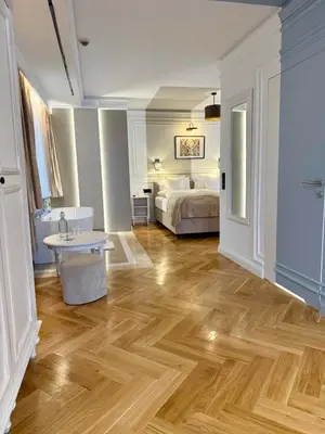a bedroom with a bed and a wooden floor at Hotel Rubinstein in Kraków