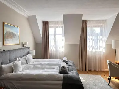 a bedroom with a bed with a dog laying on it at Hotel Rubinstein in Kraków