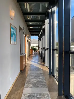 an empty hallway of a building with windows at Hotel Rubinstein in Kraków