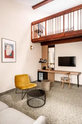 a living room with a couch and a television at Dwór w Tomaszowicach in Modlnica