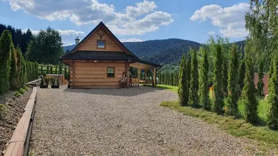 a small wooden cabin in the middle of a garden at Jodłowa Chata in Myślenice