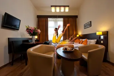 a person is jumping in the air in a living room at Spatz Aparthotel in Kraków