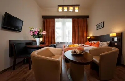 a living room with a couch and a table at Spatz Aparthotel in Kraków